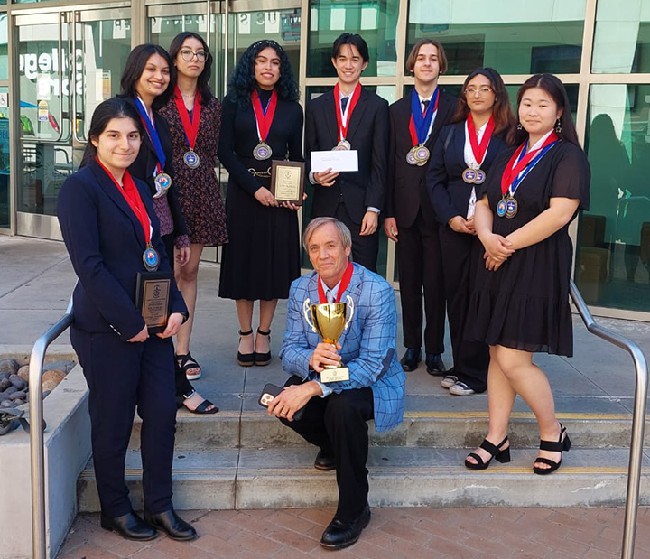 The Van Nuys High School Academic Decathlon team won 27 medals at the Regional Competition at Roybal High School. Team members (L) to (R) Mariana Poghosyan, Suhani Mehta, Daisy Cruz, Tiffany Marin, Reynold Finnegan, Drew Herbst, Priya Surajbonsi and Abby Zeng standing behind Coach Jonathan Mitchell. 