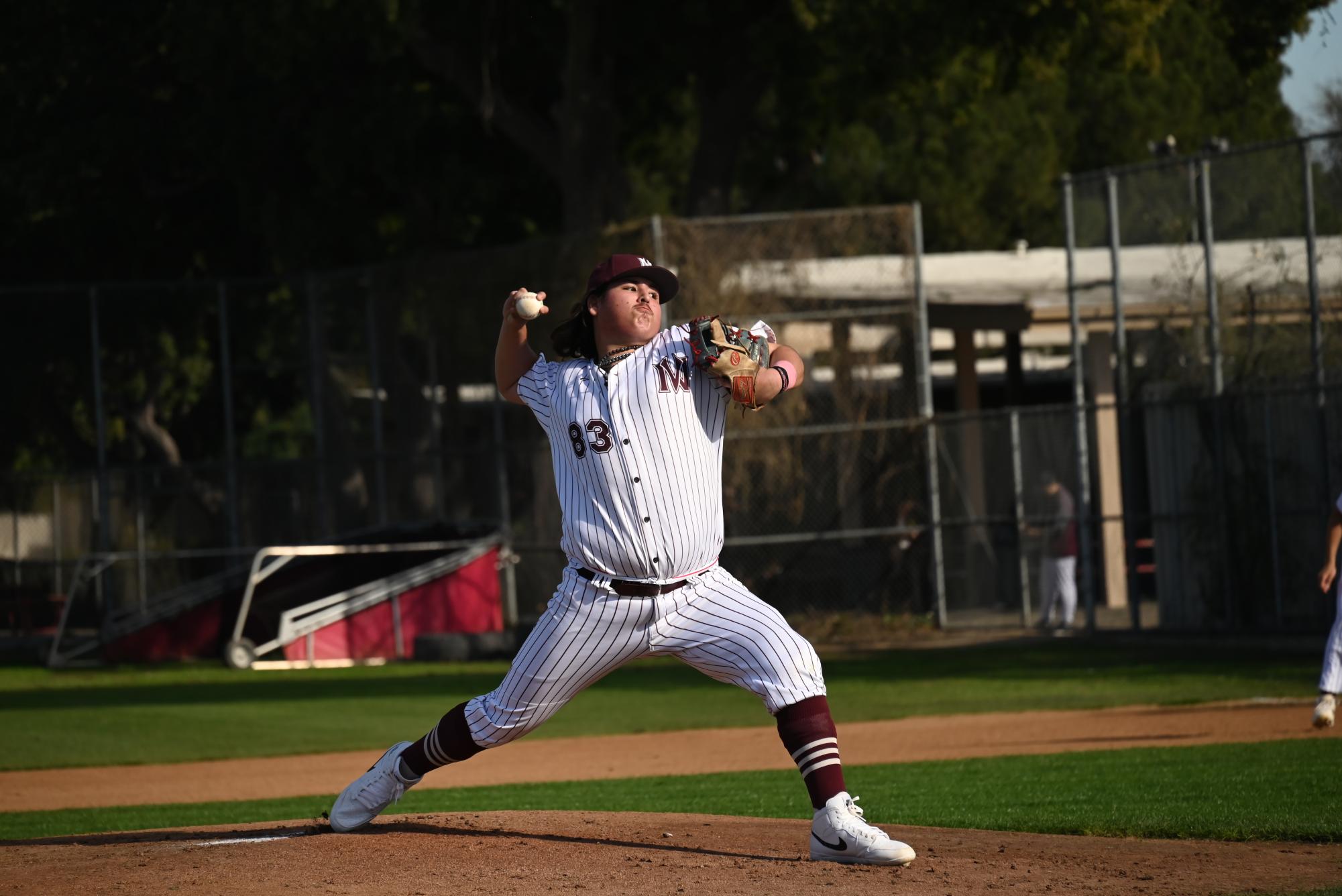 Senior Joaquin Boche sets his hand ablaze as he makes the first pitch of their season.