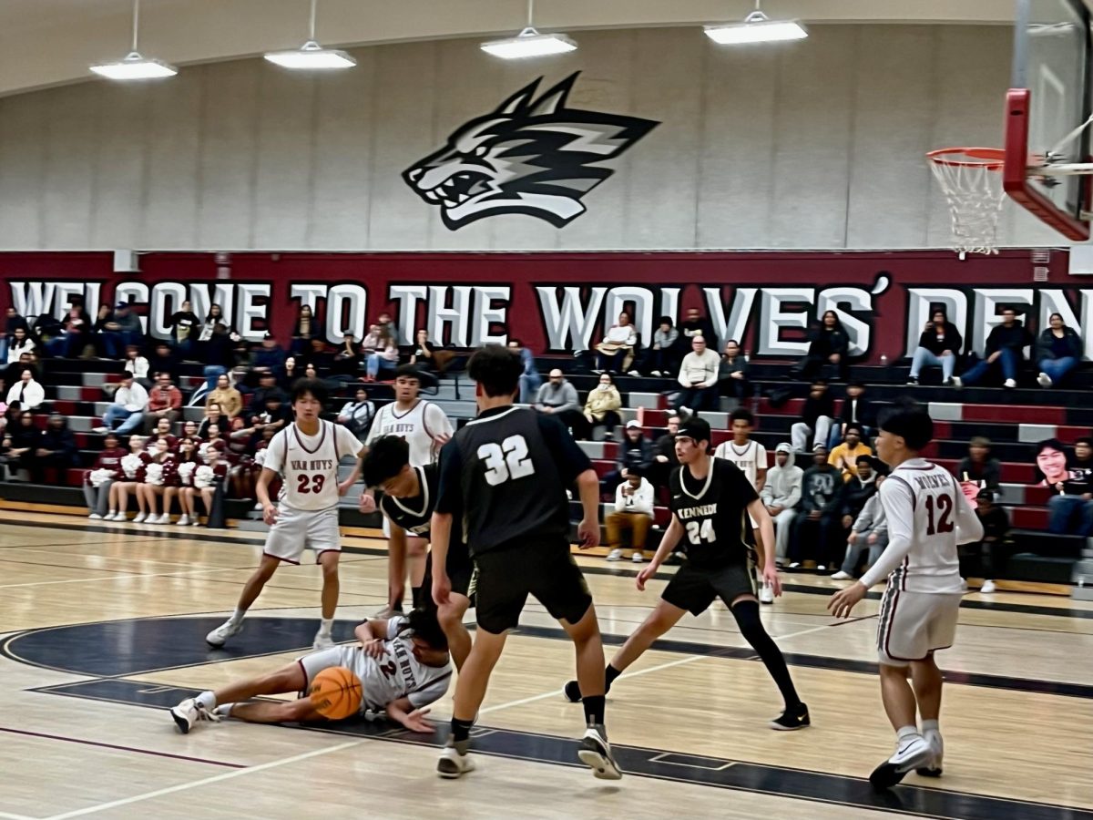 Man down! Sophomore Byron Lim falls to the floor as he chases the ball. 