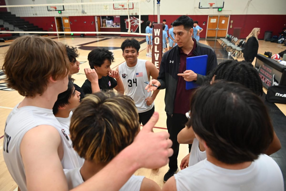  GAME WINNING PLAN  The boys volleyball team huddles to make plans which helped them win 3-2. 