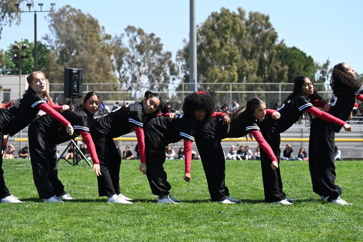 Dance company students perform various songs for the crowd.