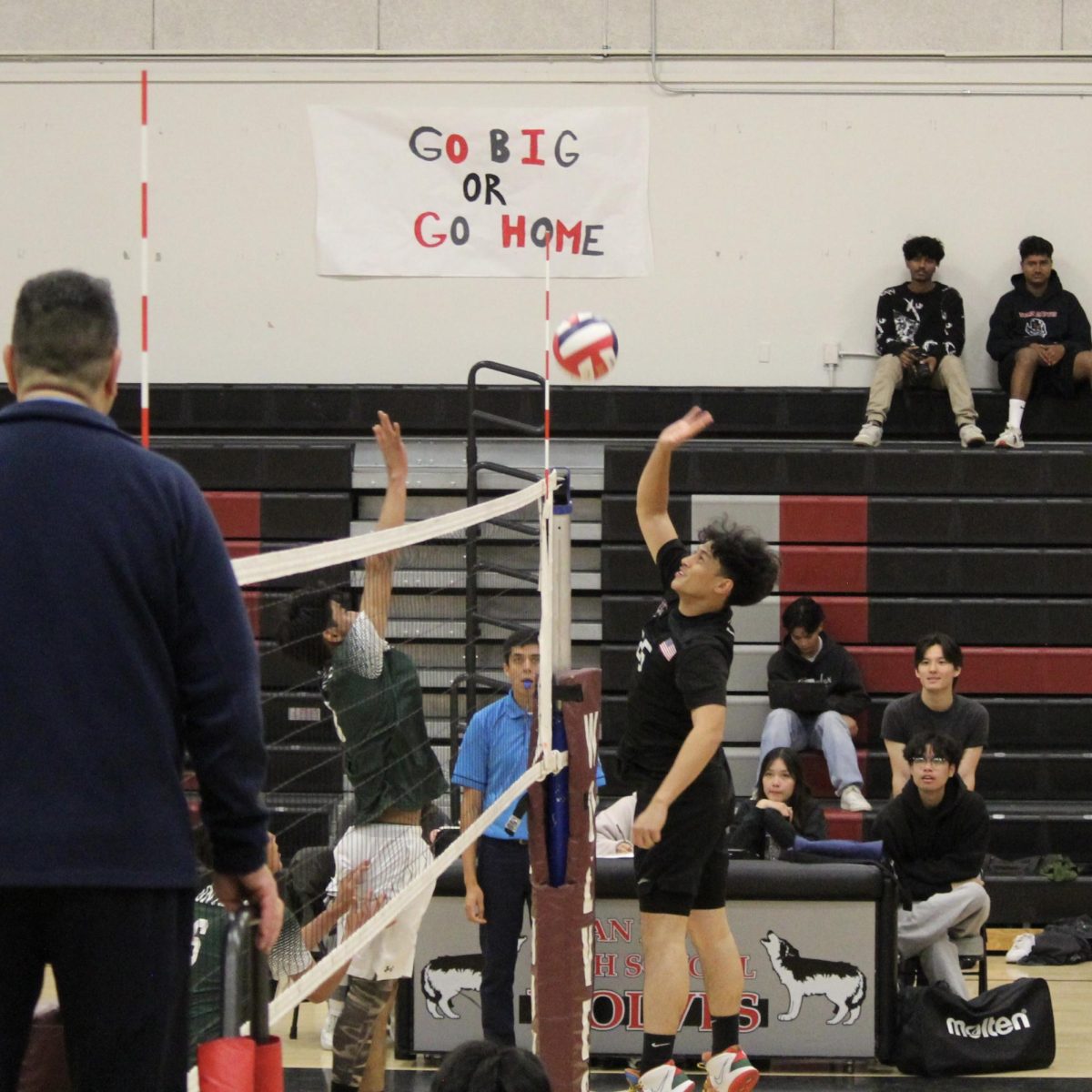 Middle blocker Xavier Lauraya faces a block during his swing