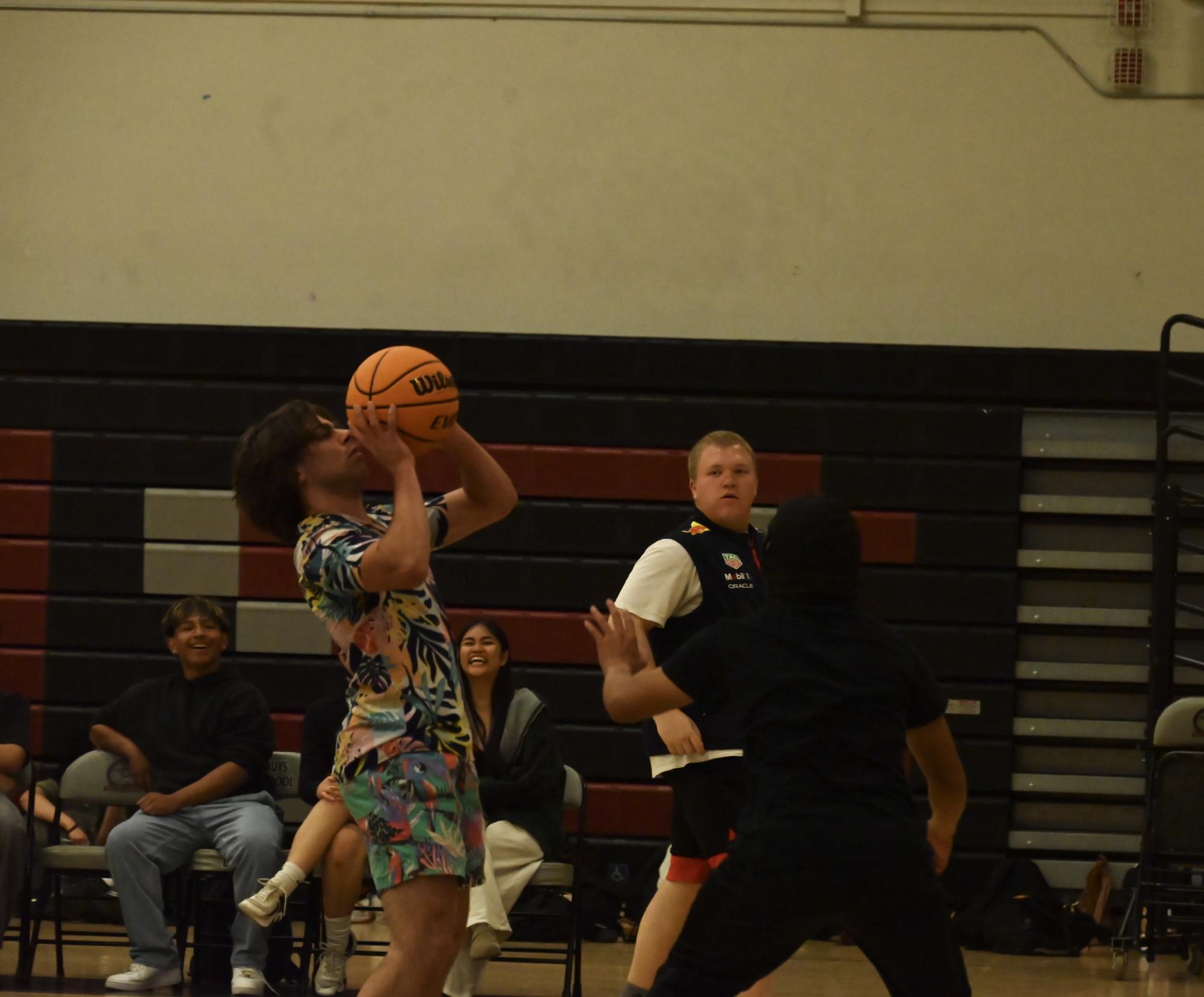 Seniors and teachers faced off in a spirited "March Madness" basketball game, showcasing school spirit and friendly competition. The event brought together students and faculty for an exciting match.
