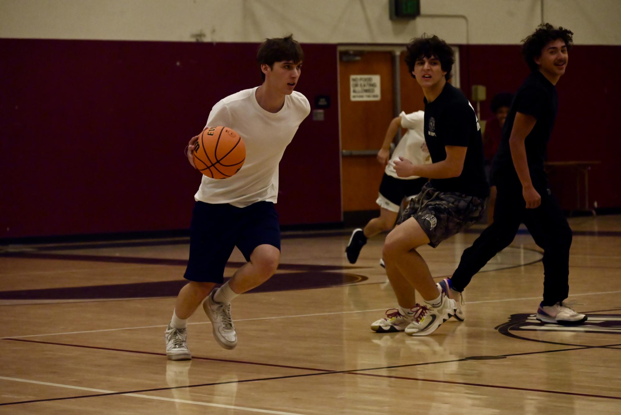 Seniors and teachers faced off in a spirited "March Madness" basketball game, showcasing school spirit and friendly competition. The event brought together students and faculty for an exciting match.