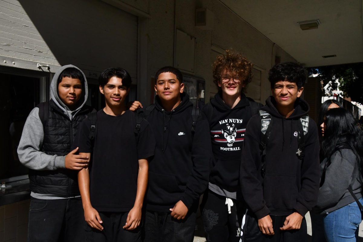 This group of freshman wear black, ranging from T-shirts to jackets.