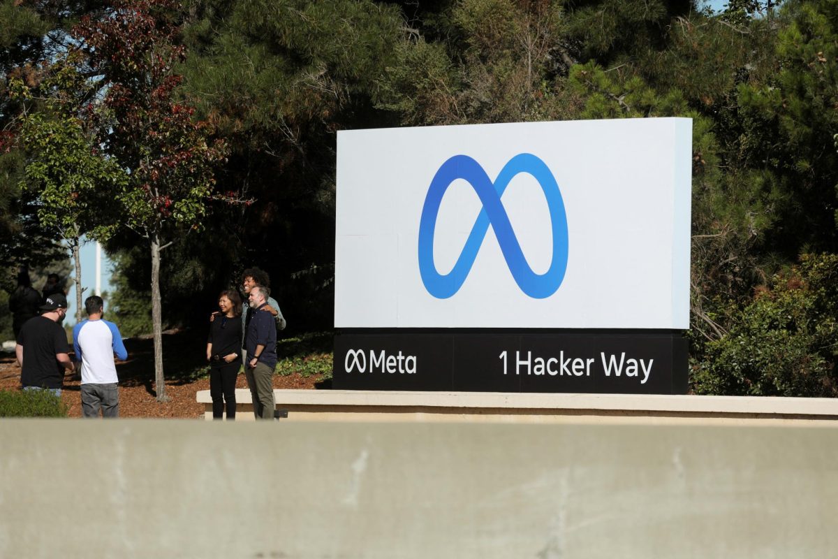 People pose for a photo in front of a sign of Meta, the new name for the company formerly known as Facebook, at its headquarters in Menlo Park, California, U.S. October 28, 2021. REUTERS | Nathan Frandino