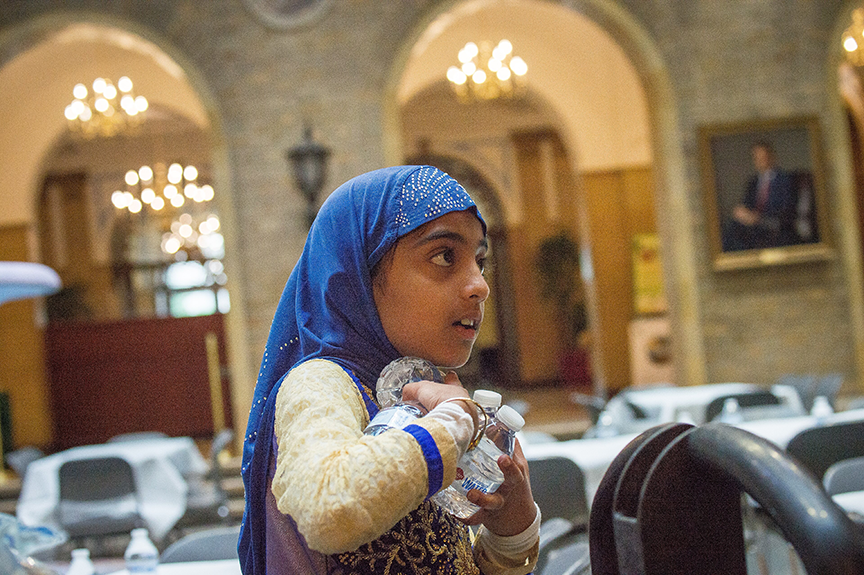 Nine-year-old Saaraa Indorewala prepares the tables for guests at an Iftar celebration in Washington, D.C. Iftar is the meal when Muslims break their Ramadan fast at sunset. U.S. DEPT. OF AGRICULTURE | LANCE CHEUNG
