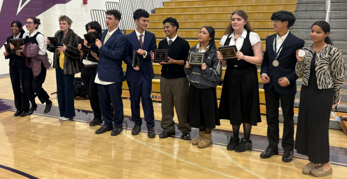 Van Nuys High School's NSDA team holding up their awards on March 7, 2026 after the state qualifier competition.  