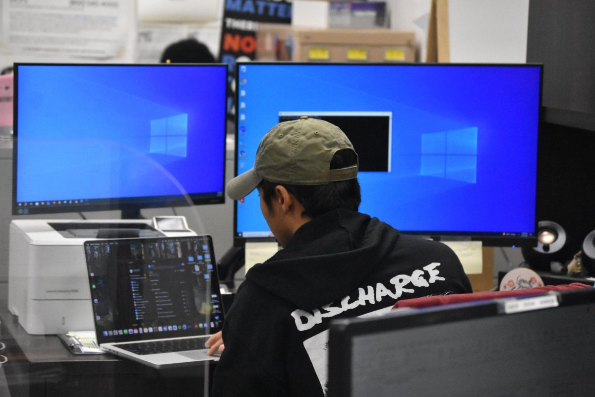 Van Nuys High School's IT technician, Andrew Kim, gets ready at his workstation VNHSMIRROR | MYAH DIAZ