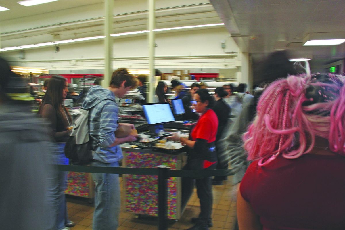 LUNCH LINES DELAYS Senior Hayes Lively pauses to scan his ID card to get lunch, causing a longer wait. VNHSMIRROR | MELOS SERA