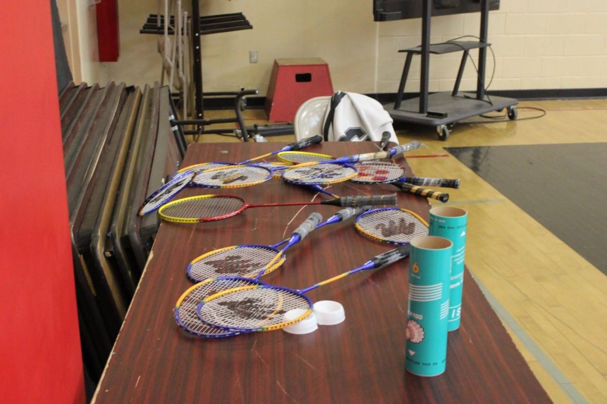 A pile of badminton rackets and birdies.